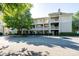 Exterior view of a multi-story condo building featuring multiple balconies, parking and mature landscaping at 18730 Nautical Dr # 102, Cornelius, NC 28031