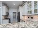 Kitchen features granite counters, tiled backsplash, stainless steel appliances, and ample lighting at 18730 Nautical Dr # 102, Cornelius, NC 28031