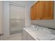Bright laundry area has side-by-side washer and dryer and a storage cabinet at 18730 Nautical Dr # 102, Cornelius, NC 28031