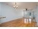 Spacious living room with hardwood floors, ceiling fan, and door to a balcony at 18730 Nautical Dr # 102, Cornelius, NC 28031