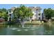 Idyllic pond view featuring a water fountain, surrounded by residential condos and lush greenery, creating a tranquil scenery at 18730 Nautical Dr # 102, Cornelius, NC 28031