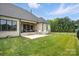 Expansive backyard featuring a covered brick patio with outdoor seating and a well-maintained lawn at 19 Berea Baptist Church Rd, Stanfield, NC 28163