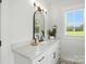 This bathroom features a marble countertop, black fixtures, and a large mirror at 19 Berea Baptist Church Rd, Stanfield, NC 28163