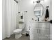 Bathroom featuring a toilet, sink with vanity, shower with curtain, and black fixtures at 19 Berea Baptist Church Rd, Stanfield, NC 28163