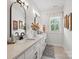 Bathroom featuring double sinks, framed mirrors, white cabinets, black fixtures, and decor at 19 Berea Baptist Church Rd, Stanfield, NC 28163