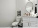 Powder bathroom featuring a toilet, mirror, sink with vanity, and black fixtures at 19 Berea Baptist Church Rd, Stanfield, NC 28163