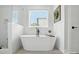 This stunning bathroom has a freestanding tub, modern fixtures, and tiled floors at 19 Berea Baptist Church Rd, Stanfield, NC 28163