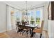 Bright dining room boasts ample natural light, stylish chandelier, and comfortable seating for memorable gatherings at 19 Berea Baptist Church Rd, Stanfield, NC 28163