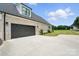 A close up image shows a gray 2-car garage with a concrete driveway at 19 Berea Baptist Church Rd, Stanfield, NC 28163