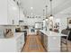 Bright kitchen features white cabinets, stainless appliances, pendant lighting, and a kitchen island with bar seating at 19 Berea Baptist Church Rd, Stanfield, NC 28163