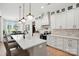 Stylish kitchen features white cabinets, stainless appliances, pendant lighting, and a kitchen island with bar seating at 19 Berea Baptist Church Rd, Stanfield, NC 28163