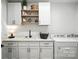 Laundry room with white shaker cabinets, shelving, countertop, black faucet, and a washer and dryer at 19 Berea Baptist Church Rd, Stanfield, NC 28163
