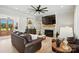 Inviting living room with a stone fireplace, large TV, ceiling fan and comfortable seating on a stylish area rug at 19 Berea Baptist Church Rd, Stanfield, NC 28163