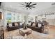 Open-concept living room with a stone fireplace, large TV, ceiling fan and comfortable seating connected to the kitchen at 19 Berea Baptist Church Rd, Stanfield, NC 28163