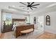 Spacious main bedroom with hardwood floors, a ceiling fan, and an ensuite bathroom at 19 Berea Baptist Church Rd, Stanfield, NC 28163