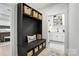 Mudroom featuring a black storage bench with baskets and a doorway to the laundry room at 19 Berea Baptist Church Rd, Stanfield, NC 28163