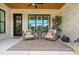 Relaxing covered patio featuring outdoor seating, wood ceiling, brick exterior, and view of the yard at 19 Berea Baptist Church Rd, Stanfield, NC 28163