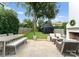 The backyard features a stone patio with dining and lounging areas, leading to a charming black shed at 2015 Lombardy Cir, Charlotte, NC 28203