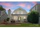 Backyard with a patio, fireplace, dining area, and charming white exterior elevation at 2015 Lombardy Cir, Charlotte, NC 28203