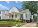 Charming home featuring a welcoming front porch, manicured landscaping, and classic architectural details at 2015 Lombardy Cir, Charlotte, NC 28203