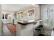 Kitchen bar with bar seating, white cabinets, and views into the main kitchen area at 2015 Lombardy Cir, Charlotte, NC 28203