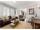 Comfortable living room with leather sofa, glass coffee table, and large windows for natural light at 2015 Lombardy Cir, Charlotte, NC 28203