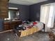 Bedroom with dark walls, dated furnishings and decor. Visible disrepair; renovation is needed at 212 Huffman Rd, Gastonia, NC 28052