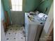 Laundry area with washer, linoleum flooring, and a door to the exterior at 212 Huffman Rd, Gastonia, NC 28052