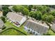 Aerial view shows homes surrounded by trees, green grass, and fenced in backyards at 2137 Whispering Way, Charlotte, NC 28212