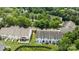 Aerial view shows the homes surrounded by green grass, fenced backyards, and shady trees at 2137 Whispering Way, Charlotte, NC 28212