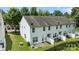 Aerial view of a home with a grass backyard and concrete patio, a fence encloses a backyard space at 2137 Whispering Way, Charlotte, NC 28212