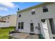 Backyard concrete patio with access to home with door and windows, overlooking the private backyard at 2137 Whispering Way, Charlotte, NC 28212