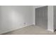 Neat bedroom features neutral carpeting and a closet for storage solutions at 2137 Whispering Way, Charlotte, NC 28212