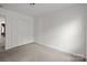 Inviting bedroom featuring neutral carpet and a closet for storage solutions at 2137 Whispering Way, Charlotte, NC 28212