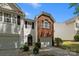Exterior view of townhouse with attached garage and brick facade accenting the exterior at 2137 Whispering Way, Charlotte, NC 28212