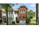 A charming townhome with white siding and a brick accent wall above the attached garage at 2137 Whispering Way, Charlotte, NC 28212