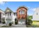 Townhouse with white siding, dark shutters, a brick accent over the garage, and a paved driveway at 2137 Whispering Way, Charlotte, NC 28212