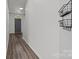 Hallway with hooks and baskets on the wall and a view of the front door at 2137 Whispering Way, Charlotte, NC 28212