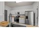 Modern kitchen features white cabinetry, stainless steel appliances and wood-look flooring at 2137 Whispering Way, Charlotte, NC 28212