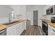 Well-designed kitchen with white cabinets, butcher block countertops and stainless steel sink at 2137 Whispering Way, Charlotte, NC 28212