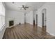 Spacious open-concept living room features a fireplace, ceiling fan and wood-look flooring at 2137 Whispering Way, Charlotte, NC 28212