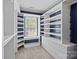 Spacious walk-in closet featuring custom shelving and natural light from the window at 2137 Whispering Way, Charlotte, NC 28212