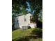 Exterior view of the back of the home and a lush green lawn at 215 9Th St, Spencer, NC 28159