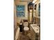 Compact bathroom with a neutral palette, modern fixtures, and built in storage at 215 9Th St, Spencer, NC 28159