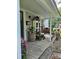 Quaint front porch featuring vintage decorations, flower pots and swing at 215 9Th St, Spencer, NC 28159