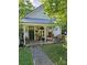 Charming cottage-style home with a quaint front porch decorated with flowers and vintage decor at 215 9Th St, Spencer, NC 28159