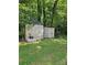 Backyard storage shed on a grassy lawn with decorative accents at 215 9Th St, Spencer, NC 28159