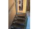 Carpeted staircase leading to an open doorway and view of a dining room at 215 9Th St, Spencer, NC 28159