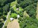 Picturesque aerial view showcasing home and barns among green landscape and fields at 233 Hicks Rd, Statesville, NC 28625
