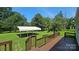 Inviting back deck with view of lush backyard and a convenient carport structure at 233 Hicks Rd, Statesville, NC 28625
